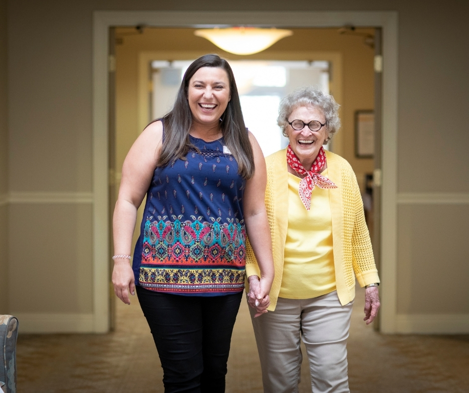 Resident and caregiver smiling