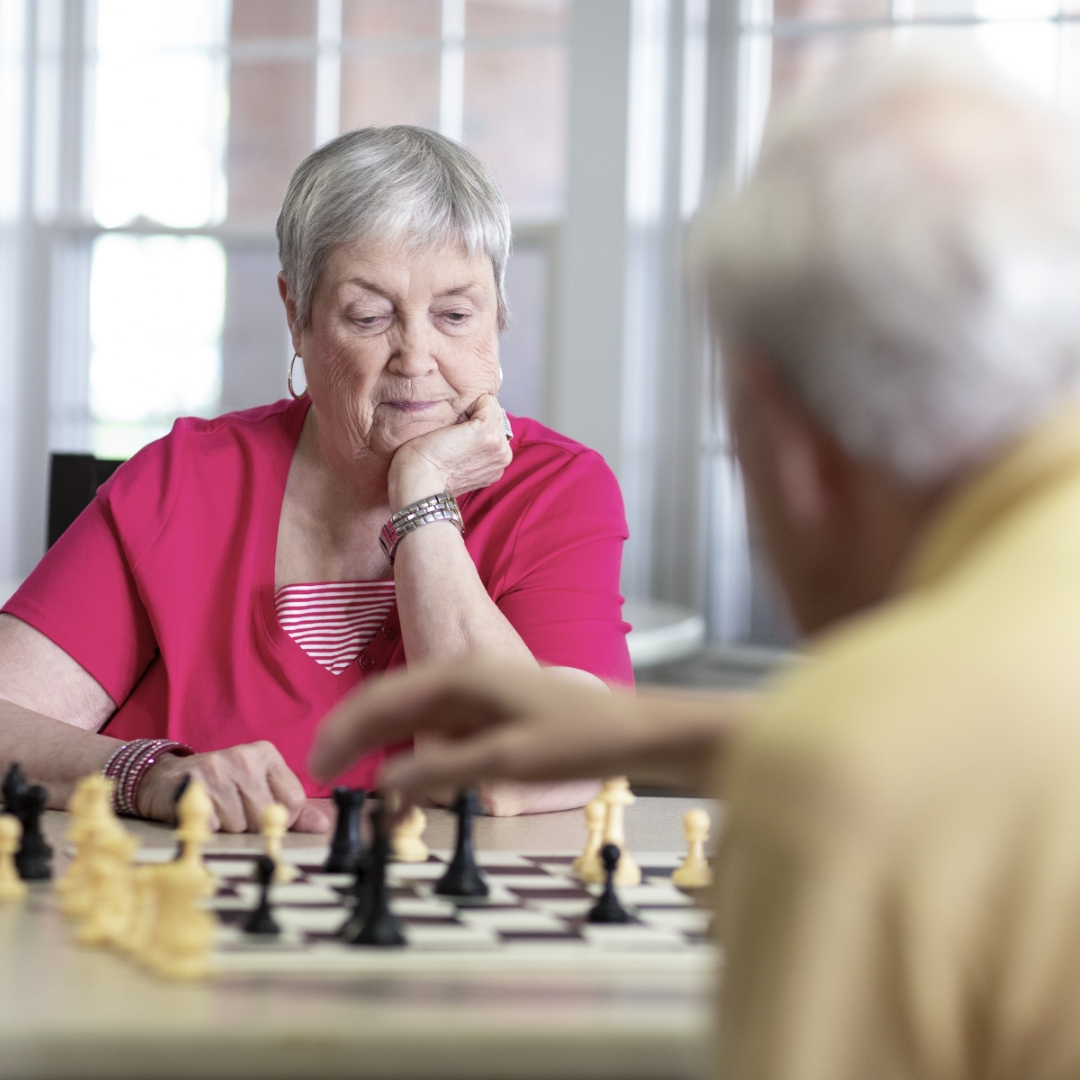 woman and man playing chess